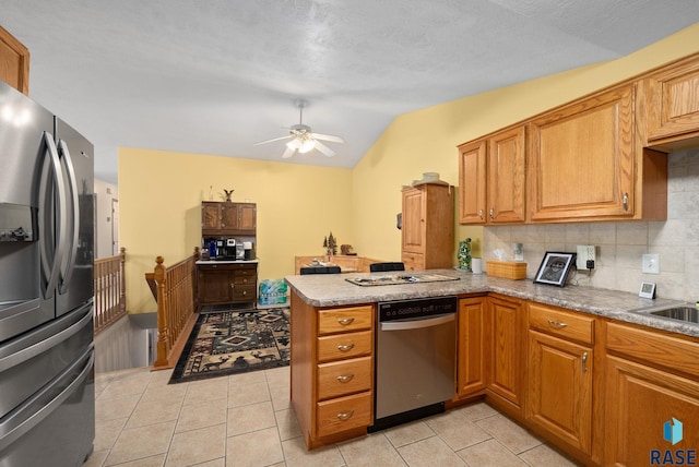 1012 E Magnolia Dr, Brandon, SD 57005 - kitchen featuring ceiling fan, stainless steel appliances, a peninsula, tasteful backsplash, and vaulted ceiling