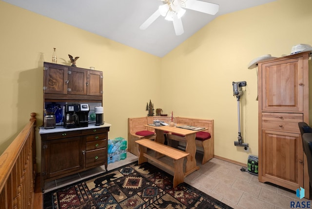 interior space featuring ceiling fan, lofted ceiling, and light tile patterned floors