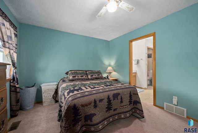 1012 E Magnolia Dr, Brandon, SD 57005 - carpeted bedroom featuring baseboards, ceiling fan, ensuite bath, and visible vents