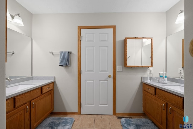 1012 E Magnolia Dr, Brandon, SD 57005 - bathroom featuring a sink, baseboards, two vanities, and visible vents