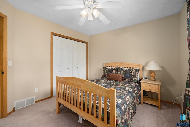 bedroom featuring baseboards, carpet, a closet, and visible vents