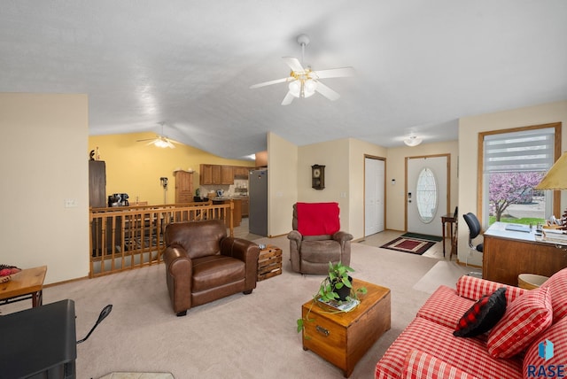 1012 E Magnolia Dr, Brandon, SD 57005 - living room with baseboards, ceiling fan, vaulted ceiling, and light carpet