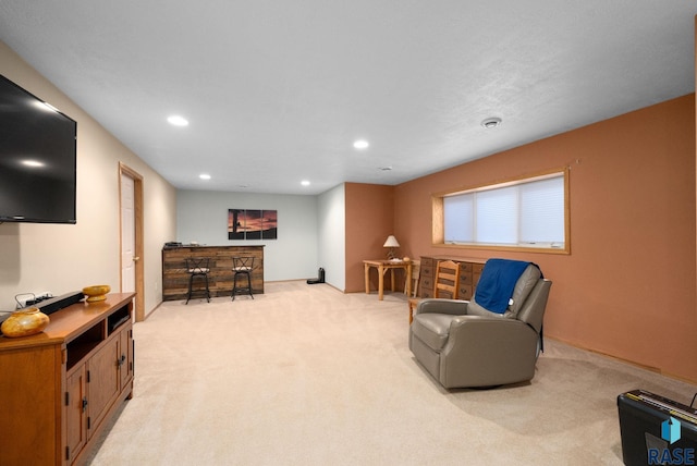 living area with recessed lighting and light colored carpet