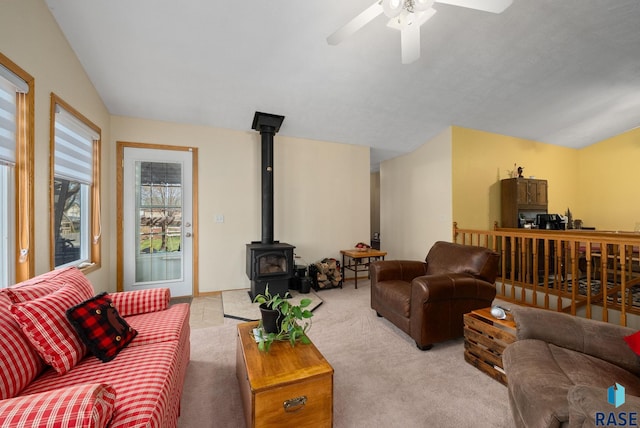 1012 E Magnolia Dr, Brandon, SD 57005 - carpeted living area featuring ceiling fan, a wood stove, and lofted ceiling
