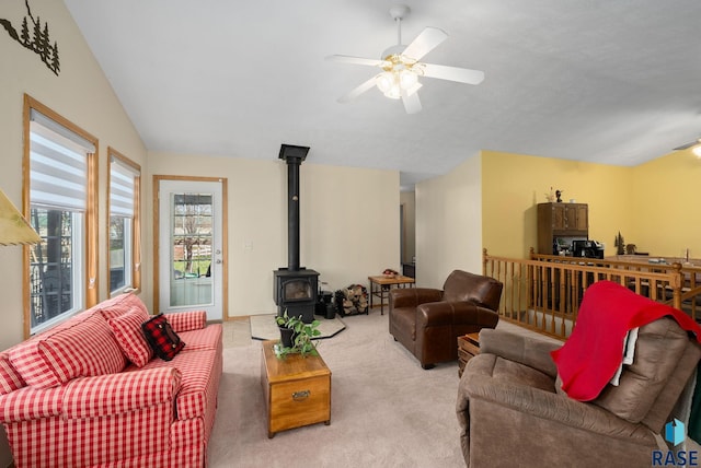 1012 E Magnolia Dr, Brandon, SD 57005 - living room featuring carpet floors, ceiling fan, a wood stove, and lofted ceiling