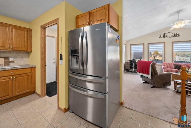 1012 E Magnolia Dr, Brandon, SD 57005 - kitchen featuring a ceiling fan, light colored carpet, stainless steel fridge, and lofted ceiling