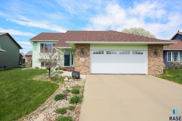 3219 S Grace Ave, Sioux Falls, SD 57103 - view of front of home with brick siding, a garage, driveway, and a front yard