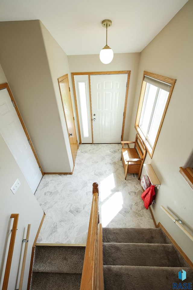 3219 S Grace Ave, Sioux Falls, SD 57103 - carpeted entryway featuring stairs and baseboards