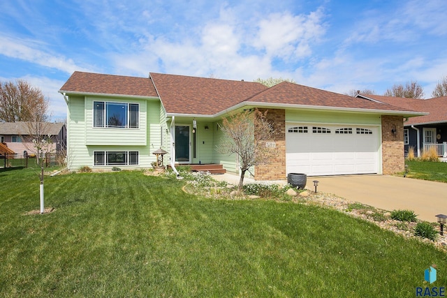 3219 S Grace Ave, Sioux Falls, SD 57103 - view of front of home with a garage, driveway, a front yard, and a shingled roof