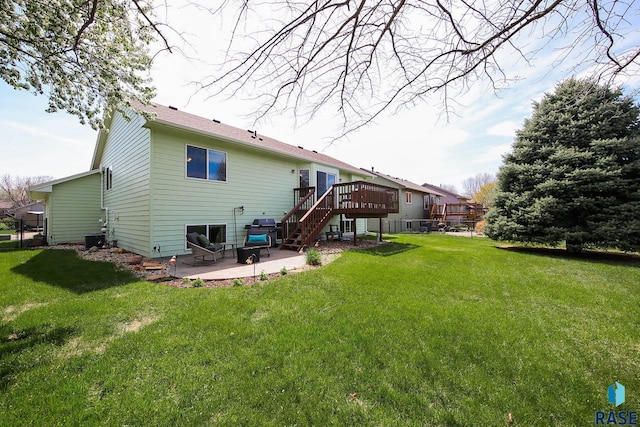 3219 S Grace Ave, Sioux Falls, SD 57103 - back of property featuring a lawn, a wooden deck, stairs, and a patio area