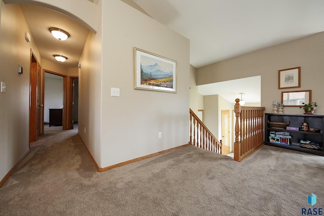 3219 S Grace Ave, Sioux Falls, SD 57103 - hallway with arched walkways, baseboards, carpet, and an upstairs landing