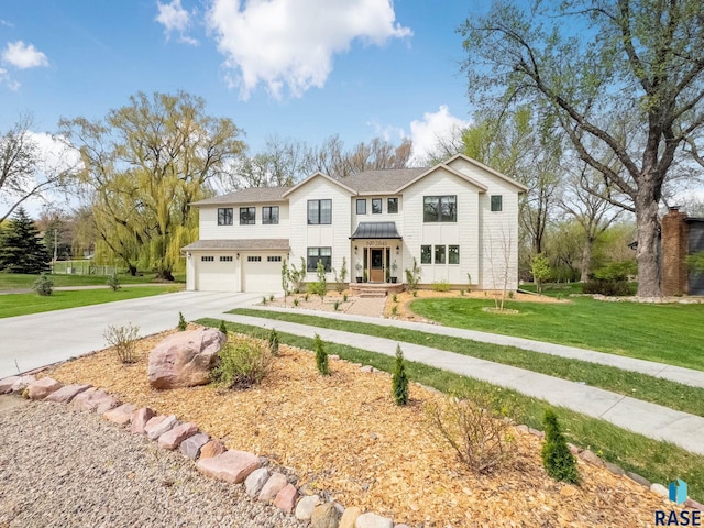 traditional home with a garage, a front lawn, a standing seam roof, and concrete driveway