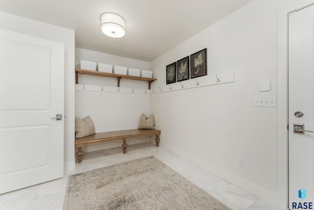 mudroom with baseboards and marble finish floor