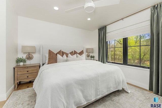 bedroom featuring baseboards, recessed lighting, ceiling fan, and wood finished floors