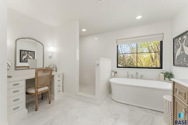 bathroom with a freestanding tub, walk in shower, vanity, marble finish floor, and recessed lighting
