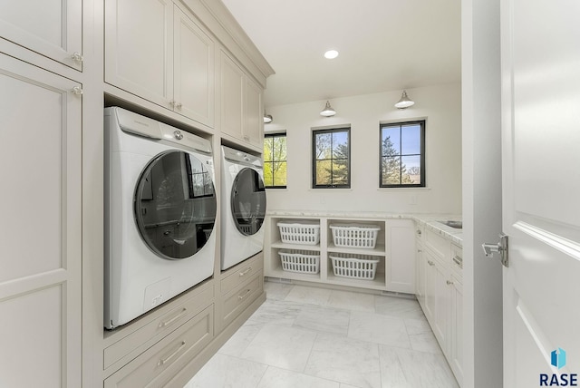 laundry room with recessed lighting, marble finish floor, cabinet space, and independent washer and dryer