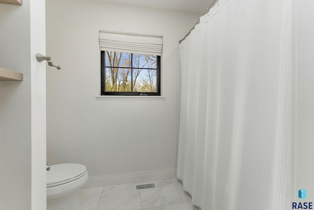 bathroom with visible vents, marble finish floor, baseboards, and toilet