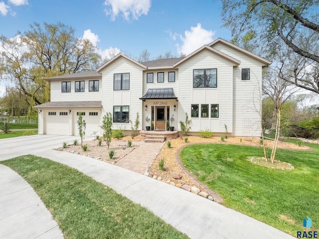 traditional-style home featuring a front lawn, a garage, a standing seam roof, driveway, and metal roof