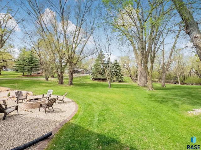 view of yard featuring an outdoor fire pit