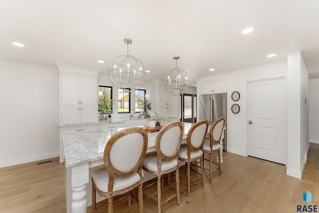 kitchen with white cabinets, recessed lighting, a chandelier, and a center island