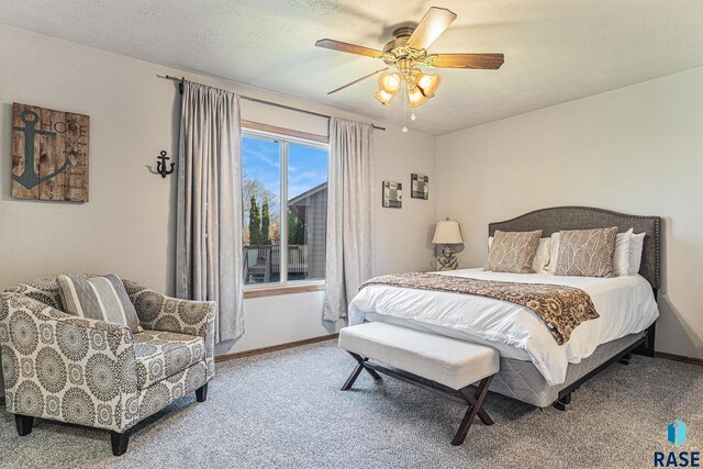carpeted bedroom featuring baseboards and a ceiling fan