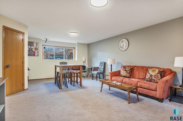 living room featuring baseboards and carpet