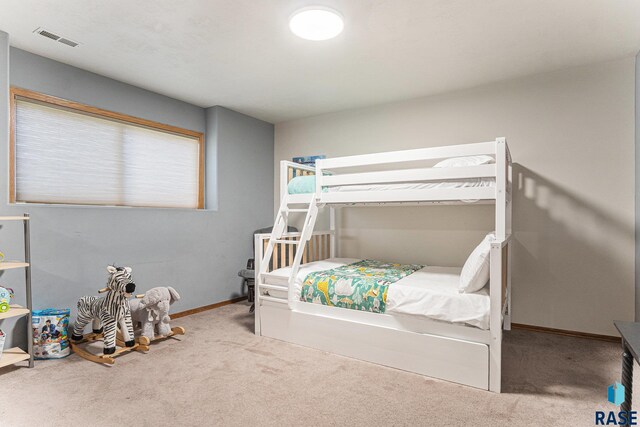 carpeted bedroom with baseboards and visible vents