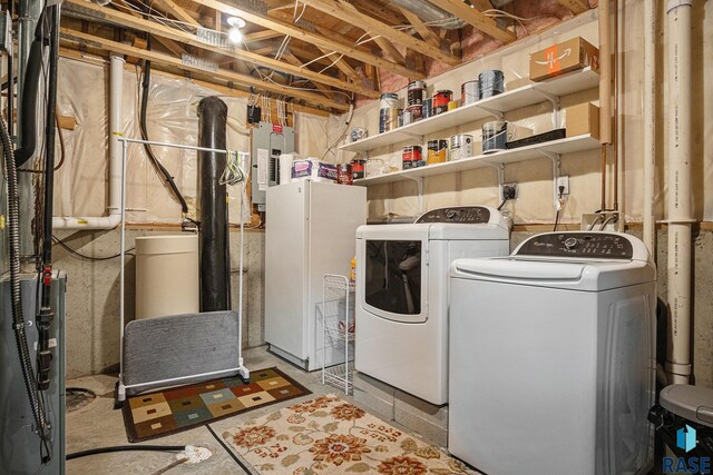 laundry room featuring washing machine and clothes dryer, laundry area, and electric panel