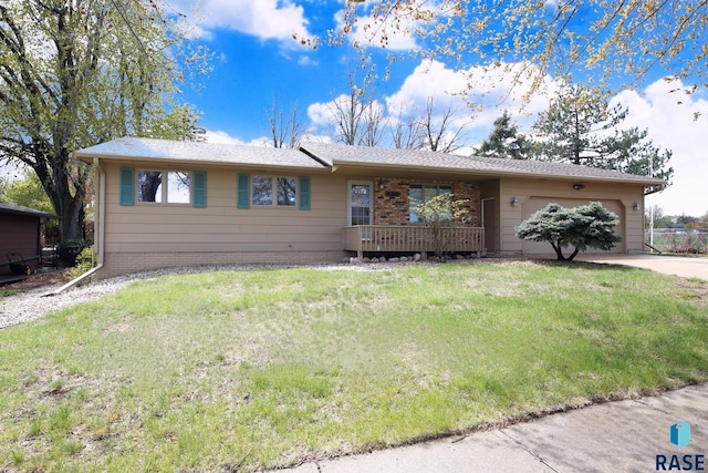 single story home featuring an attached garage, a front lawn, brick siding, and concrete driveway