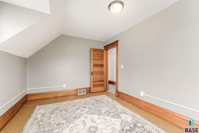 333 S Juniper Ave, Parker, SD 57053 - additional living space with visible vents, baseboards, lofted ceiling, and wood finished floors