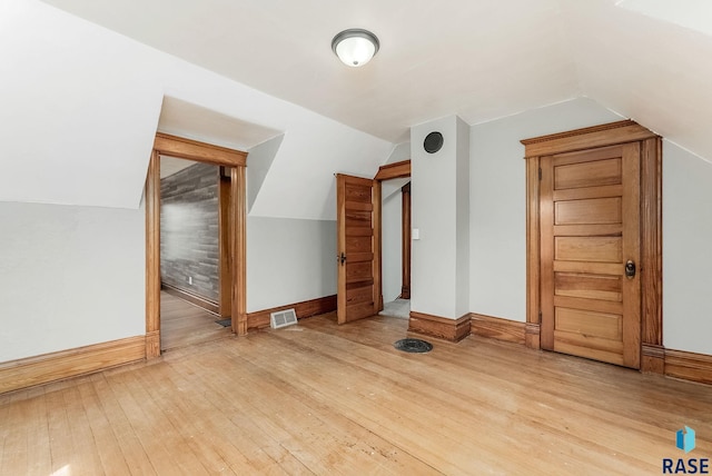 333 S Juniper Ave, Parker, SD 57053 - additional living space with baseboards, visible vents, vaulted ceiling, and hardwood / wood-style floors