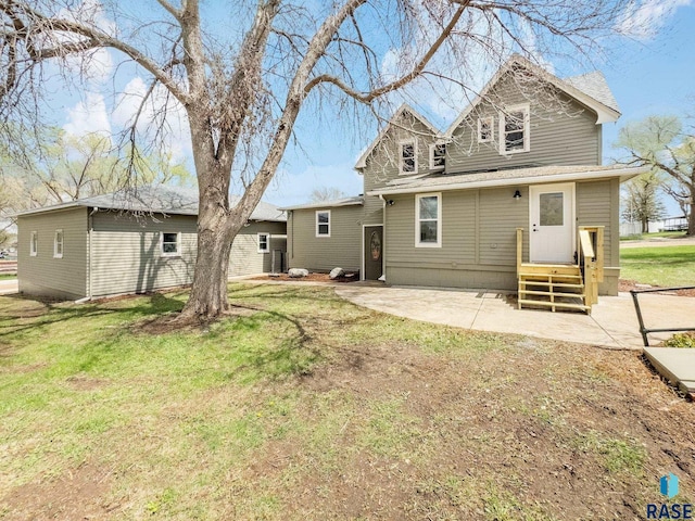 333 S Juniper Ave, Parker, SD 57053 - rear view of house with a patio area and a yard