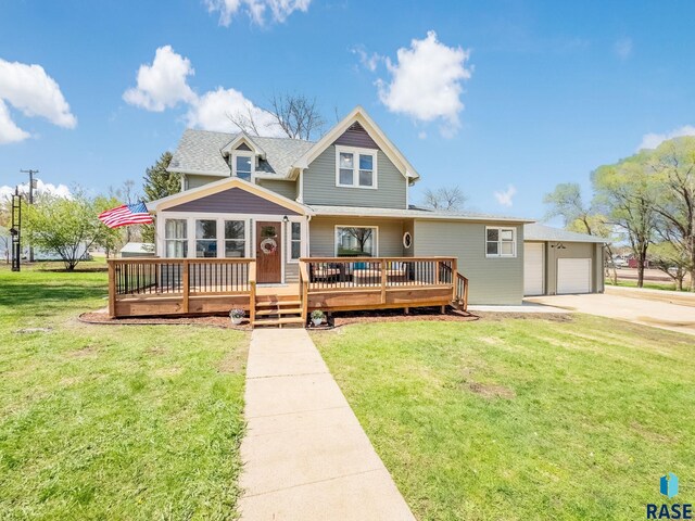 333 S Juniper Ave, Parker, SD 57053 - view of front facade featuring an attached garage, a front lawn, a wooden deck, and concrete driveway