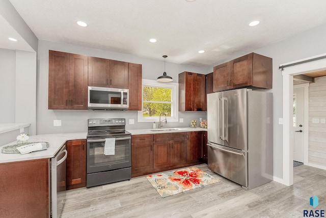333 S Juniper Ave, Parker, SD 57053 - kitchen with a sink, light wood-style floors, light countertops, stainless steel appliances, and recessed lighting