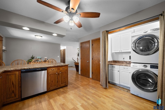 4108 E 23rd St, Sioux Falls, SD 57103 - clothes washing area with ceiling fan, laundry area, light wood finished floors, stacked washing maching and dryer, and recessed lighting