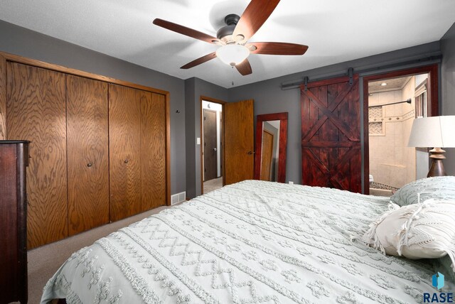 4108 E 23rd St, Sioux Falls, SD 57103 - carpeted bedroom featuring a closet, a barn door, a ceiling fan, and visible vents