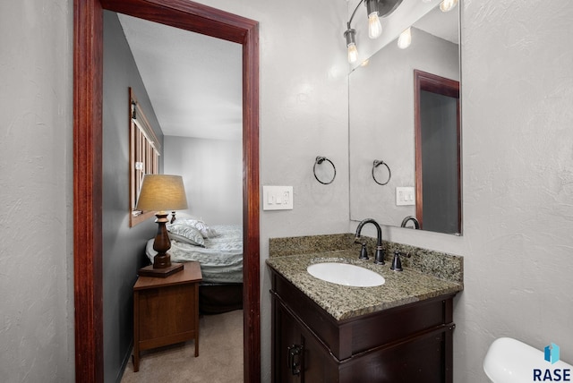 4108 E 23rd St, Sioux Falls, SD 57103 - bathroom with vanity, a textured wall, and toilet
