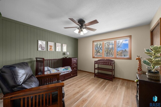 4108 E 23rd St, Sioux Falls, SD 57103 - bedroom with baseboards, a ceiling fan, a textured ceiling, and light wood-style flooring