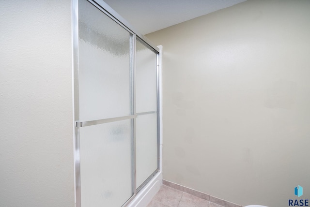 4108 E 23rd St, Sioux Falls, SD 57103 - bathroom featuring baseboards, tile patterned flooring, and a stall shower