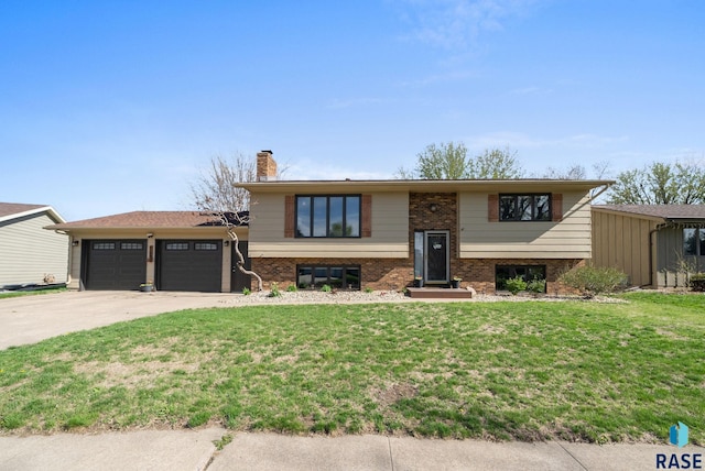4108 E 23rd St, Sioux Falls, SD 57103 - bi-level home with an attached garage, driveway, a front lawn, and brick siding