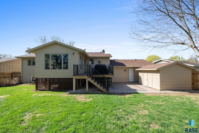 4108 E 23rd St, Sioux Falls, SD 57103 - back of property with fence, a chimney, stairs, a patio area, and a yard