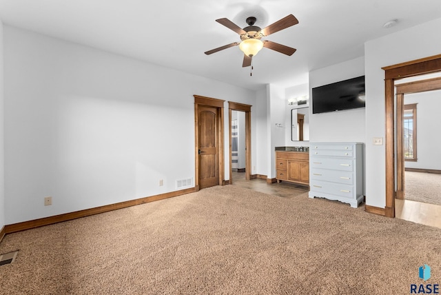 unfurnished bedroom featuring carpet floors, baseboards, visible vents, and ensuite bath