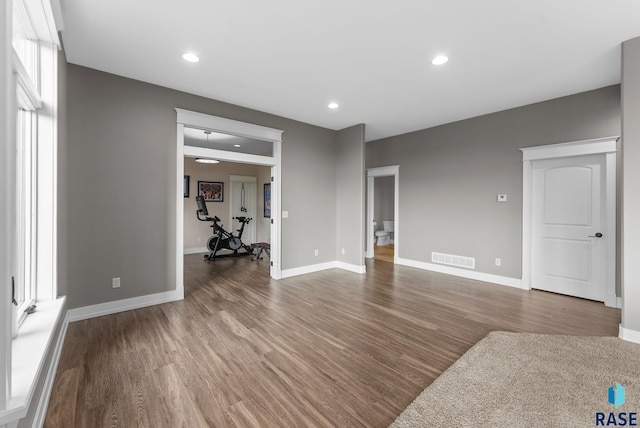 unfurnished living room with baseboards, recessed lighting, wood finished floors, and visible vents