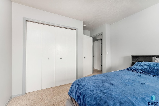 carpeted bedroom featuring a closet