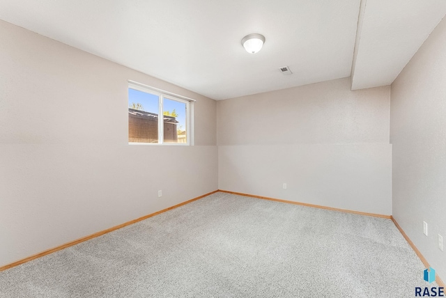 spare room with carpet floors and baseboards