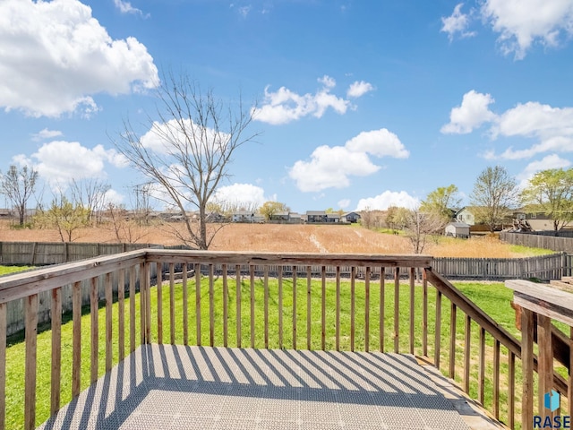 wooden deck featuring a fenced backyard and a yard