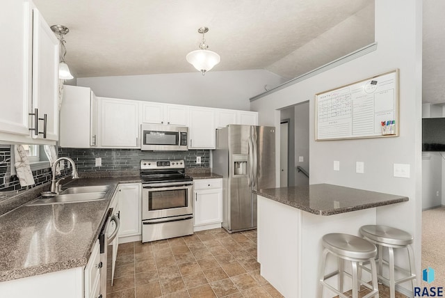 kitchen featuring a sink, white cabinetry, backsplash, and stainless steel appliances