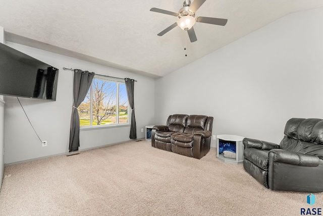 sitting room with carpet floors, ceiling fan, and lofted ceiling