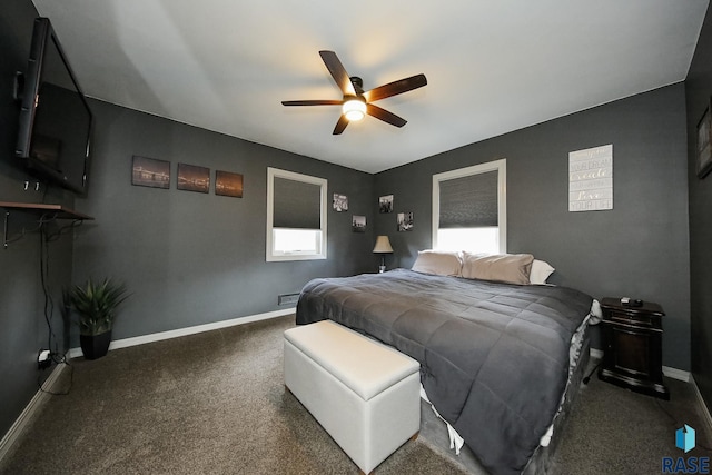 carpeted bedroom featuring baseboards and a ceiling fan