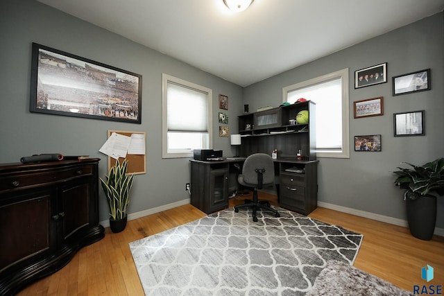 home office featuring baseboards and light wood-type flooring